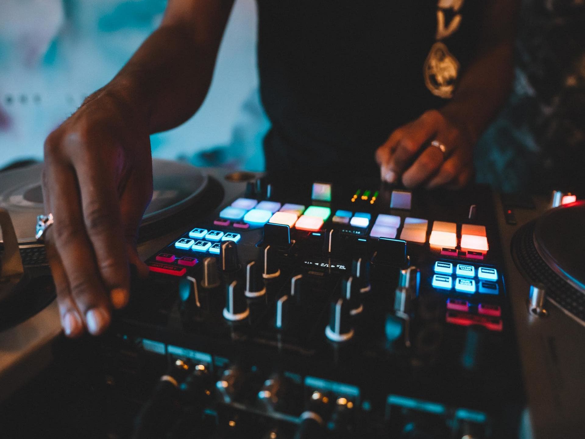 DJ using a turntable with multicoloured lights